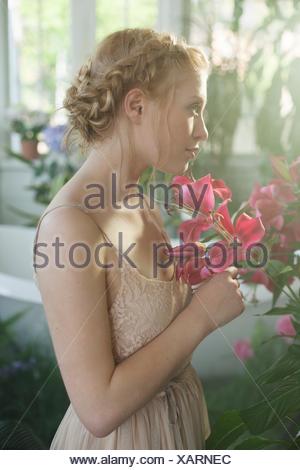 Young Woman With Blonde Plaited Hair Looking Away Stock Photo