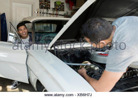 Father And Son Restoring Vintage Car Engine Garage Stock Photo