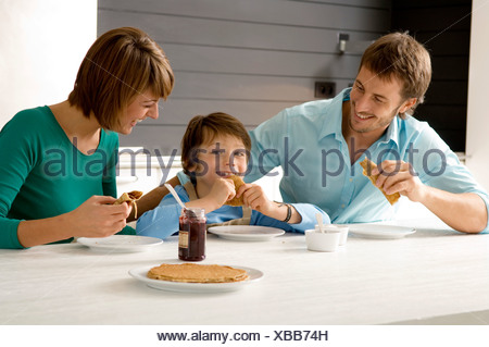 https://l450v.alamy.com/450v/xbb74h/mid-adult-man-and-a-young-woman-having-breakfast-with-their-son-xbb74h.jpg