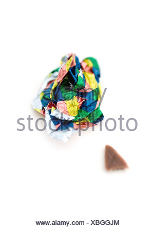 Crumpled candy wrapper and small piece of chocolate Stock Photo ...