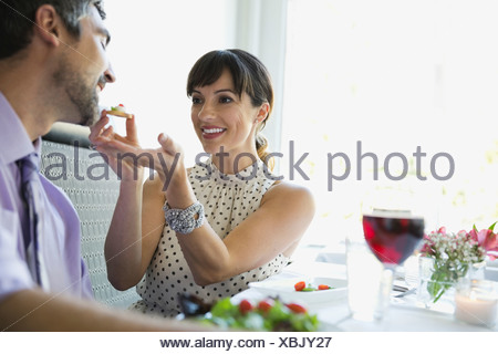 https://l450v.alamy.com/450v/xbjy27/woman-playfully-feeding-man-in-a-restaurant-xbjy27.jpg
