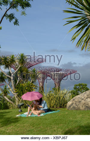Mother and daughter sitting under a parasol in Gardens by the Bay, Singapore