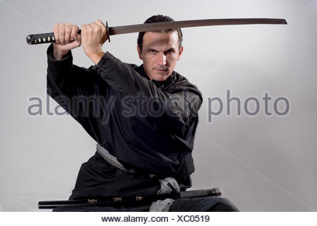 Man holding a real samurai sword during a swordsmanship exercise called ...
