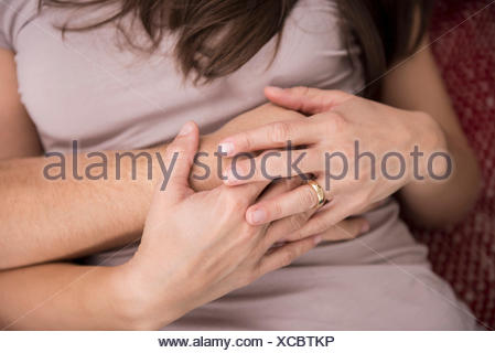 Mid section view of a couple holding hands, Munich, Bavaria, Germany