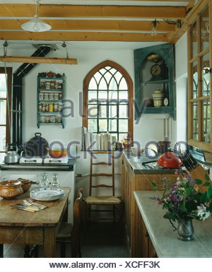 Antique Corner Cupboard Beside Arched Gothic Window In Country