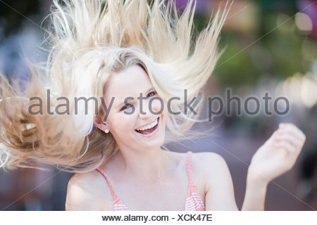 Blond girl shaking her hair