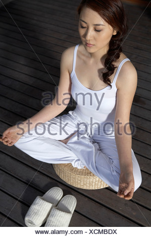 Woman Meditating On Deck