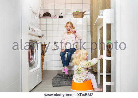 Girl sitting by the toilet bowl Stock Photo: 7537380 - Alamy