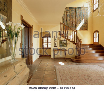 Large Tapestry On Wall Above An Antique Inlaid Bookcase At Eastnor