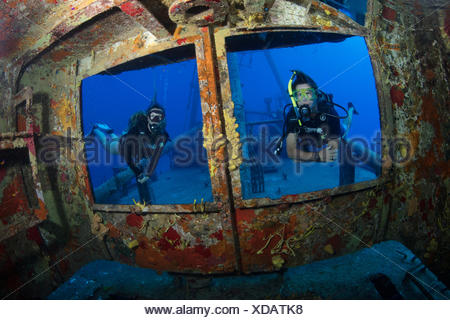 Divers peer through windows on bridge of USS Kittiwake