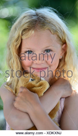 Little girl with blonde hair and cuddly toy, Sweden Stock Photo - Alamy