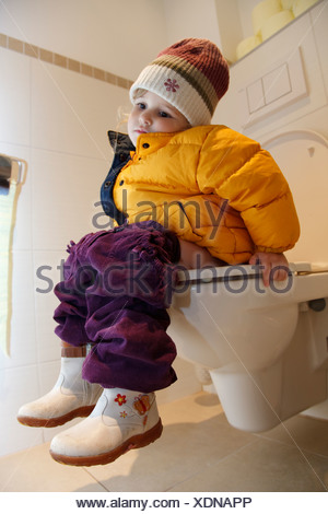 Young Girl Sitting On Toilet High Resolution Stock 