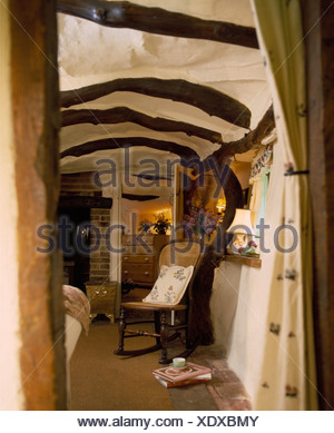 Cane Back Rocking Chair In Small Cottage Living Room With Wood