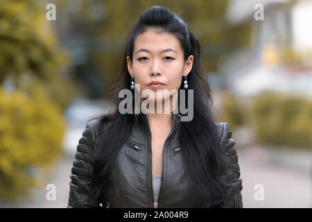 Angesichts des schönen asiatischen rebellische Frau im Freien Stockfoto