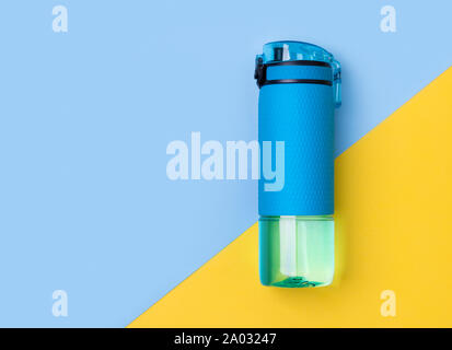 Blaue Flasche Wasser. Sport Trinken auf kreativen Hintergrund. Fitness Gym gesunde Lebensweise Konzept. Stockfoto