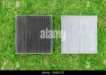 Schmutzig und neues Auto Innenraumfilter Vergleich auf grünem Gras Stockfoto
