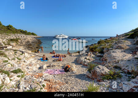 Menschen Sonnenbaden an Perna Strand auf der Inselgruppe Pakleni Inseln in Kroatien Stockfoto