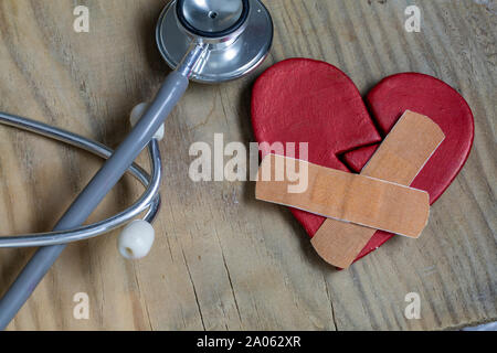 Gebrochenes Herz, Gips mit einem Stethoskop Stockfoto