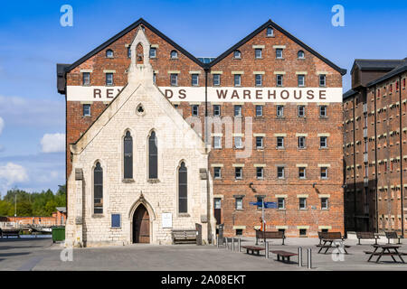 GLOUCESTER QUAYS, ENGLAND - September 2019: Die seemänner Kirche der regenerierten ehemaligen Docks in Gloucester Quays. Dahinter ist ein altes Lager Stockfoto