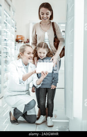 Mutter und Tochter an der Drogist s Tablet suchen interessiert Stockfoto