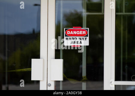 Schild, das einen Schutzhelm in einer Bauzone benötigt Stockfoto