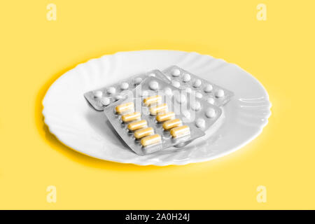 Verschiedene Tabletten auf einem Teller. Das Konzept der verschreibungspflichtigen Medikamente zur Gewichtsreduktion. Mittel zur Unterdrückung des Appetits. Stockfoto