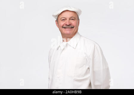 Reifen hispanic Chef lächelt auf weißem Hintergrund. Erfahrene man freut sich für Sie zu kochen. Stockfoto