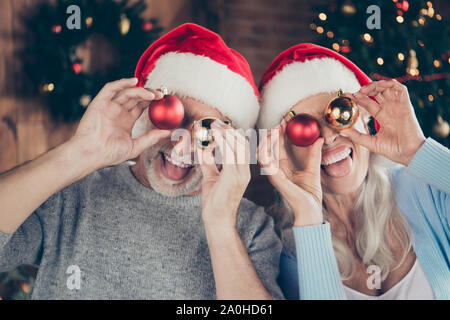 Close-up Portrait von zwei fröhliche positive verspielten nette grauhaarige Leute verheiratet Ehegatten Oma opa Holding runde glänzend glänzend Spielzeug für Cl Stockfoto