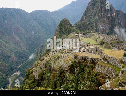 Machu Picchu ist ein Inka Zitadelle hoch in den Anden in Peru, über dem Fluss Urubamba Tal. Im 15. Jahrhundert erbaut und später aufgegeben, es ist für seine elegante Trockenmauern, dass Sicherung riesige Blöcke ohne die Verwendung von Mörtel, faszinierende Gebäude, die auf astronomische Ausrichtungen und Panoramablick spielen bekannt. Seine genaue ehemalige Nutzung bleibt ein Geheimnis. Es steht 7,970 Fuß (2.430 Meter) über dem Meeresspiegel am Osthang der Anden Stockfoto