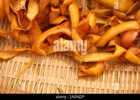 Persimone persimone Chips (getrocknete Häute - Diospyros kaki) Trocknen im Freien in einem geflochtenen Korb an einem Herbsttag in Vinstra, Japan. Stockfoto