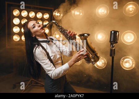 Weibliche saxophonist spielt das Saxophon auf der Bühne Stockfoto