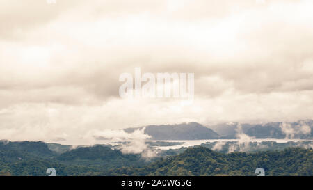 Panoramablick auf die drohne Blick auf schneebedeckte Berge im Herbst, Luftaufnahme über Schweizer Alpen mit See in Nebel in Kanchanaburi Thailand abgedeckt Stockfoto