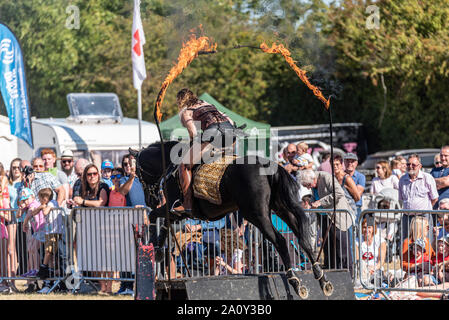 Equestrienne Stunt zeigt Pferd Anzeige an den nationalen Land Show Live im Hylands Park, Chelmsford, Essex, Großbritannien. Horse Event Team Stockfoto