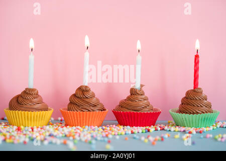 Schokolade geburtstag Cupcakes mit den brennenden Kerzen Stockfoto