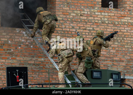 Ukrainische Soldaten Vorschuss auf ihr Ziel mit einer Leiter bei einem Brand team Bewegung und Zimmer clearing Demonstration als Teil der Schnellen Trident 2019, Sept. 20, 2019, in der Nähe der Yavoriv, Ukraine. RT19 ist eine jährliche, multinationale Übung, die ca. 3.700 Mitarbeiter aus 14 Nationen, die Unterstützung gemeinsamer kombinierte Interoperabilität zwischen den Partnerländern der Streitkräfte der Ukraine und den Vereinigten Staaten sowie im Rahmen der Partnerschaft für den Frieden der Nationen und NATO-Verbündeten. (U.S. Armee Foto von Pvt. Joanna Gaona Gomez) Stockfoto