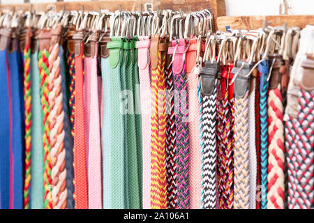 Haufen sortierte bunte Bänder hängen an Rack auf Marktstand Stockfoto