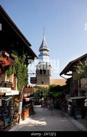 Geschäfte und Restaurants in der Rue de l'église Saint Pancrace führen zu der Kirche in der mittelalterlichen Stadt Yvoire, Frankreich. Stockfoto