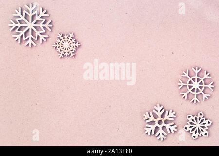 Abstract Pink christmas background, Pappe Papier Textur mit hölzernen Schneeflocken. Vintage Hintergrund Kopie Raum Stockfoto