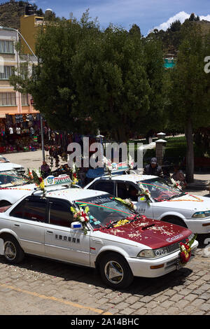 COPACABANA, BOLIVIEN - Oktober 20, 2014: Eingerichtet Taxis stehen in der Linie für die Segnung vor der Basilika in Copacabana, Bolivien Stockfoto