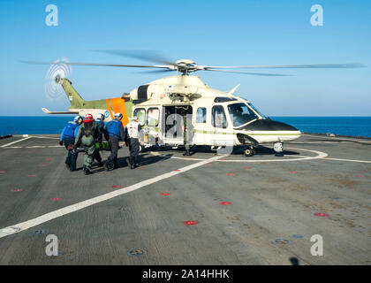 Matrosen tragen einen simulierten Unfall eine AW-139 Rettungshubschrauber. Stockfoto