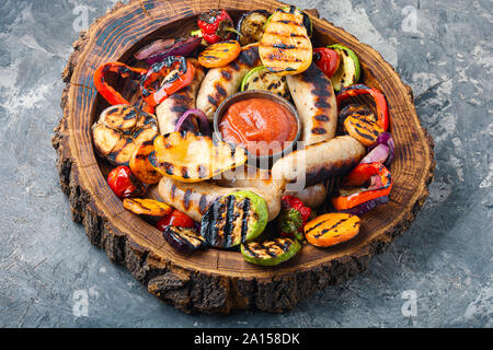 Gegrillte Würstchen gebraten mit Birne und Gemüse. Herbst essen. Stockfoto