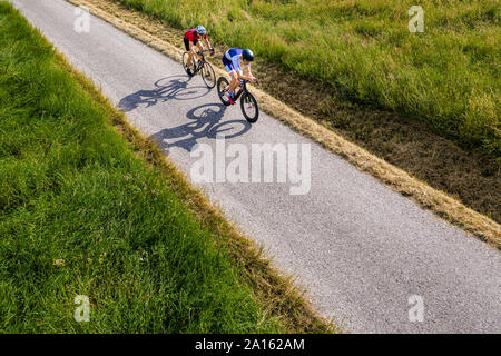 Triathleten Reiten Fahrrad auf Landstraße, Deutschland Stockfoto