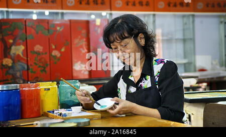 (190924)-BEIJING, Sept. 24, 2019 (Xinhua) - Hu Xin macht Pigment für Lack Malerei in Peking Gold Lack eingelegten Co., Ltd. mit Sitz in Beijing, die Hauptstadt Chinas, Sept. 20, 2019. Gold Einlegearbeiten aus Lack, ein integraler Bestandteil der lackiert und Einlegearbeiten aus Lack, ist unter den acht Peking Stil Kunsthandwerk. Gold mit Intarsien Lackarbeiten verbindet die komplexen Fähigkeiten der Carving-, Abfüll-, Whetting, Einlegearbeit und Malerei. Es verfügt über eine gold lackierte Oberfläche mit verschiedenen Edelsteinen und anderen exotischen Materialien. Hu Xin, eine 62-jährige Senior Kunst und Handwerk Meister von Peking, hat zu entwerfen und zu creati gewidmet. Stockfoto