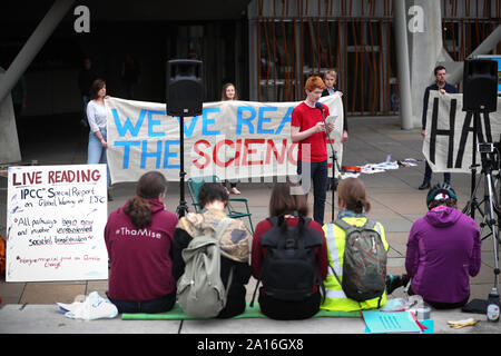 Sandy Boyd, der schottischen Jugend Klima Streik, außerhalb des schottischen Parlaments in Edinburgh vor MSPs Ihre endgültige Abstimmung über Schottland's neue Klimawandel Bill Casting. Boyd lesen Sie die Sehenswürdigkeiten UN-IPCC-Sonderbericht über 1.5C, die besagt, dass Maßnahmen dringend muss innerhalb der nächsten zehn Jahre erhöhen. Stockfoto