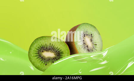 Frische kiwi mit Saft auf grünem Hintergrund Stockfoto
