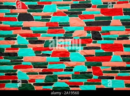Multicolor rot und schwarz Mauer Nahaufnahme Stockfoto