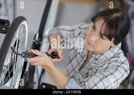 Frau Pumpen - bis ein Fahrrad Reifen mit der kleinen Pumpe Stockfoto