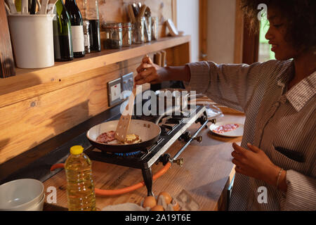 Junge Frau kochen Frühstück zu Hause Stockfoto