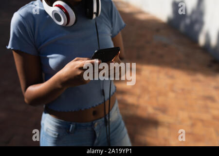 Junge Frau mit Smartphone im freien Stockfoto