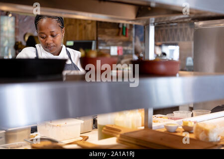 Frau arbeitet im Restaurantküche Stockfoto
